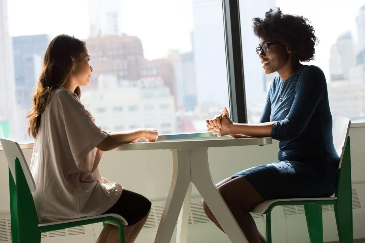 two-woman-at-table-1200x800