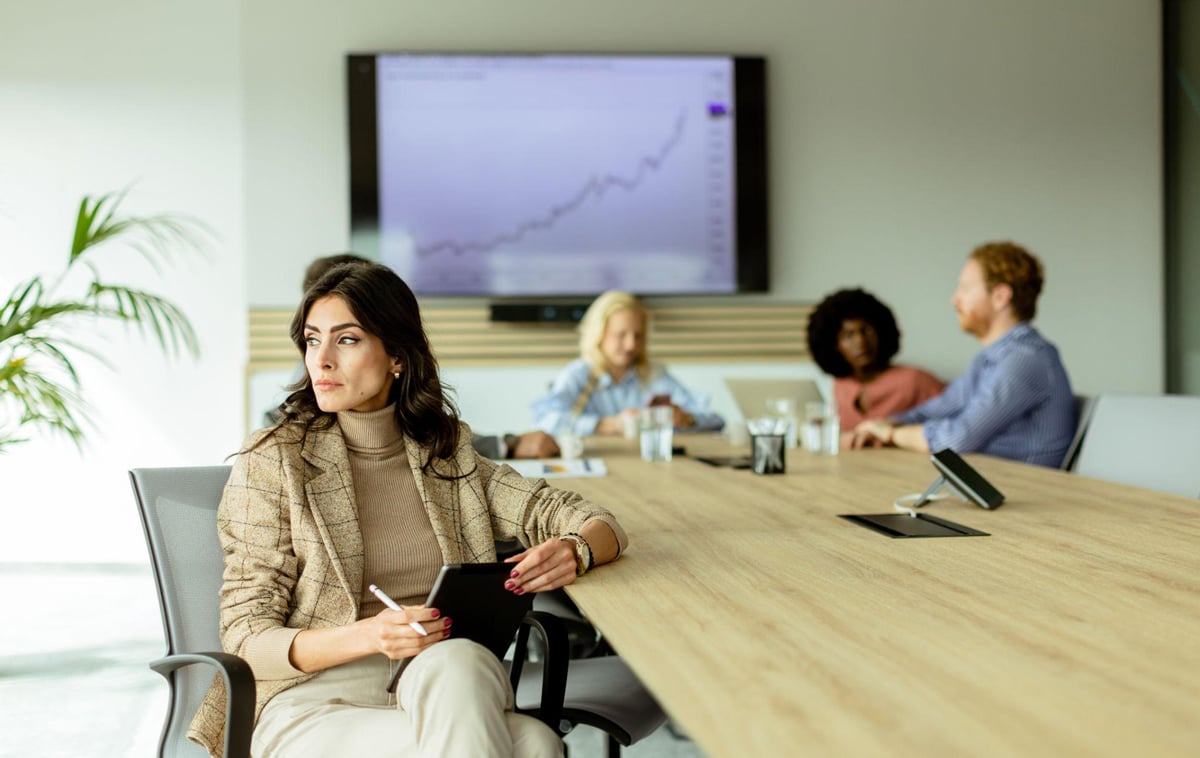 woman-looking-away-from-group-1200x758